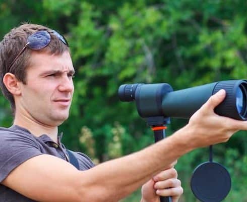 someone is holding a scope